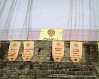 Hanging Ganana Kodi (Flags) around Pesa Walalu (outer rings of Ruwanweliseya stupa)