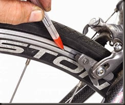 The Brakes grip the tire....here....causing resistance and the tire to spin more slowly.