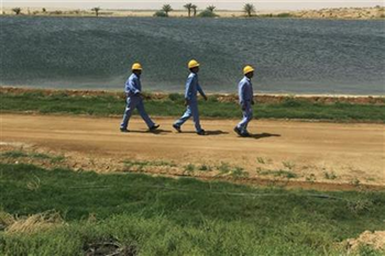 Workers walk outside a desalination plant, south of Riyadh, Saudi Arabia, 4 May 2011. Fahad Shadeed / Reuters
