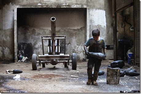 Issa, 10, carries a mortar shell in a weapons factory of the Free Syrian Army in Aleppo, September 7 - Copy Issa, 10, carries a mortar shell in a weapons factory of the Free Syrian Army in Aleppo, September 7 - Copy