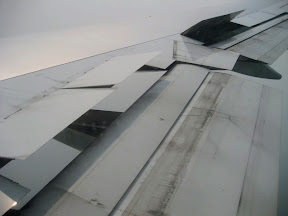 Flaps extended and spoilers up to cut lift.