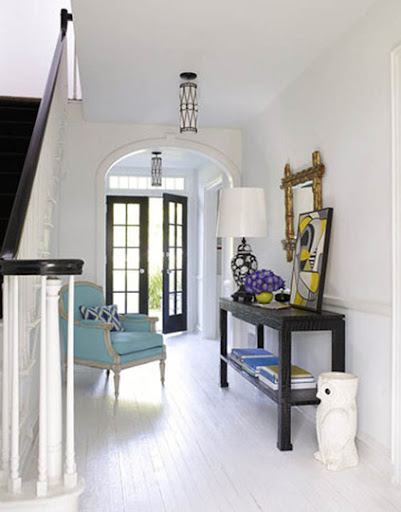 A turquoise chair gives a burst of energy to this entryway. (Jonathan Adler) A turquoise chair gives a burst of energy to this entryway. (Jonathan Adler)