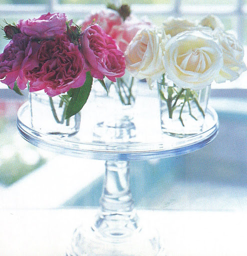 Three glass tumblers filled with three colors of roses top a cake stand for a pretty, light-filled centerpiece. (The Best of Martha Stewart Living -- Arranging Flowers) Three glass tumblers filled with three colors of roses top a cake stand for a pretty, light-filled centerpiece. (The Best of Martha Stewart Living -- Arranging Flowers)