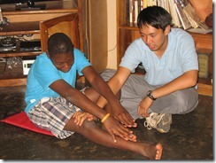 Physical therapist Simon Tsang teaching Luke a new exercise