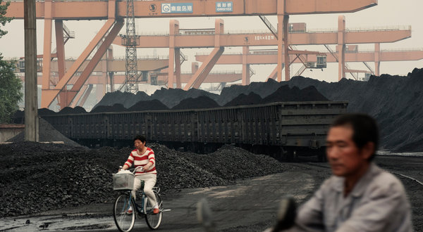 Coal stockpiled at Qinhuangdao port, one of the largest coal storage areas in China, reached 9.5 million tons in June 2012. Record-setting mountains of excess coal have accumulated at the country's biggest storage areas because power plants are burning less coal in the face of tumbling electricity demand. Gilles Sabrie for The New York Times