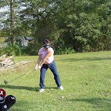 Pam practices golf swing.