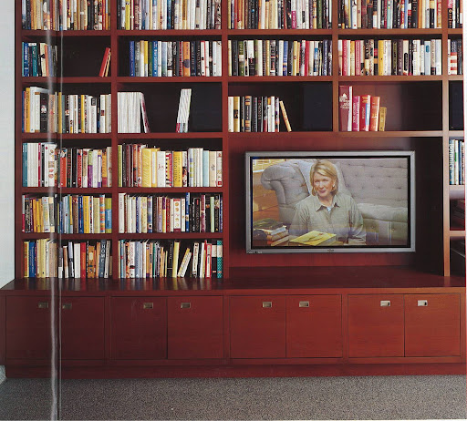 This media cabinet executes its job perfectly by camouflaging the wires of the TV, keep DVDs, home movies and photos accessible (via a chic row of drawers below), and flanking itself with a library of home-keeping reference books. This media cabinet executes its job perfectly by camouflaging the wires of the TV, keep DVDs, home movies and photos accessible (via a chic row of drawers below), and flanking itself with a library of home-keeping reference books.