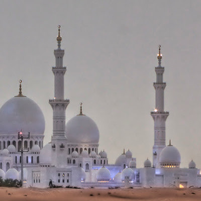 This photo has made it to #30 on Explore for May 24, 2009.....thanks everyone!One of the most magnificent structures I have ever seen...the Sheikh Zayed Mosque in Abu Dhabi is lit up at night, but the color will vary depending something to do with the moon (If anyone knows, please tell). This was taken at dusk just as they were starting to light it up with a purple color.A bit more from Wikipedia:Sheikh Zayed Mosque in Abu Dhabi is the largest mosque in the United Arab Emirates and the sixth largest mosque in the world. It is named after Sheikh Zayed bin Sultan Al Nahyan, the founder and the first President of the United Arab Emirates, who is also buried there. The mosque was officially opened in the Islamic month of Ramadan in 2007.Although it is illegal for non-Muslims to enter mosques in the United Arab Emirates, this mosque will be an exception. The Abu Dhabi Tourism Authority announced that tours of the mosques will be given to both Muslims and non-Muslims beginning in m 3559608689.jpg