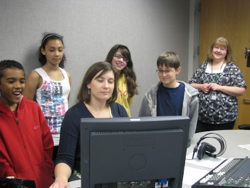 Students watch as their news update is edited.
