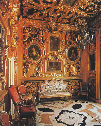 An ancient Italian fortress is richly carved and gilded, framing family portraits. Crazy beautiful. An ancient Italian fortress is richly carved and gilded, framing family portraits. Crazy beautiful.