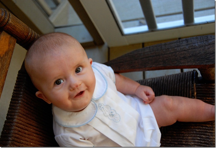 in rocking chair smiling