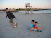 Paul pulling Kai and Eidan across the sand Paul pulling Kai and Eidan across the sand