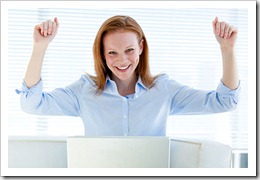 Bright business woman punching the air Bright business woman punching the air