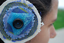 Circular hair clip stitched up with fabrics, scarf and a button.