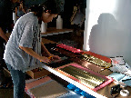 Here, Julie cuts gold fringe for the photo-booth backdrop.