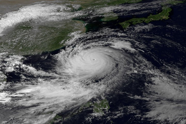 Satellite view of Typhoon Usagi, the most powerful typhoon of the year, which swept through the Luzon Strait separating the Philippines and Taiwan on Saturday, 21 September 2013, battering island communities and dumping rain as it approached landfall Sunday in Hong Kong. The storm system dumped up to 520 millimeters (20 inches) of rain along the eastern and southern coasts of Taiwan in a 20-hour period. Photo: JMA via NOAA