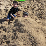 Eidan burying Kai at Waikiki beach