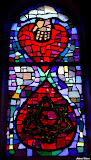 A symbol of God’s love. A hand from heaven, centered in a heart, is reaching down to mankind and below comes a drop of blood with a crown of thorns inside – in the form of the Star of David.
He, who bore the crown of thorns for all humanity, was born within the chosen people of Israel, since it was through this people God would bless all the peoples of the earth (Genesis 12 / Galatians 3). StainedWindows-1006.jpg