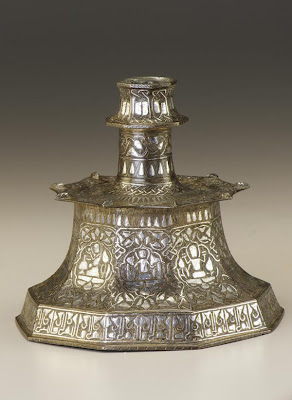 Brass candlesticks | Origin:  Iran | Period: 13th century  Saljuq period | Details:  Not Available | Type: Brass, inlaid with silver | Size: H: 16.3  W: 18.0  cm | Museum Code: F1954.128 | Photograph and description taken from Freer and the Sackler (Smithsonian) Museums.