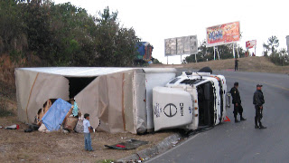 Flipped truck on the road up to Chichi. The road in and out of Chichi goes up and down thru a canyon with 30' turn radius at a 30 percent slope...We thank Victor for his safe driving. Photos by TOM HART