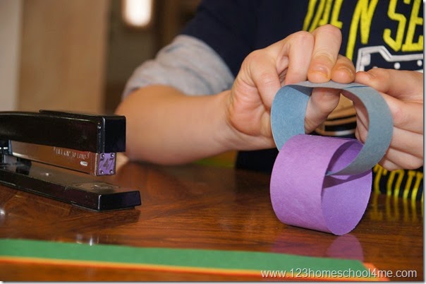 Make links with strips of construction paper and a stapler Make links with strips of construction paper and a stapler