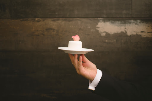White mini cakes with a light pink rose on top (layers of caramel sponge cake, chocolate mousse, chocolate-covered almonds and caramel were in each) were served, as were traditional 