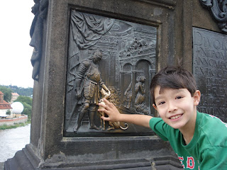 Kai at the statue of St John Nepomuk on the Charles Bridge