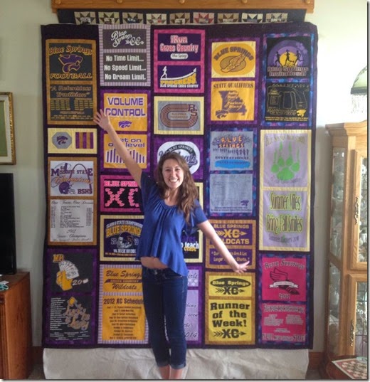 emily in front of her quilt