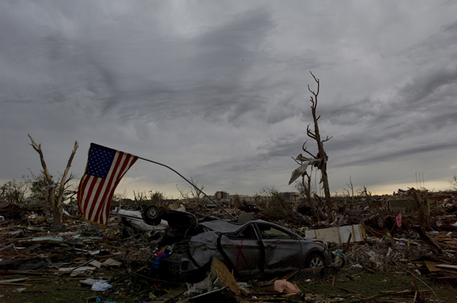 An American flag droops in the remains of a destroyed home in Moore, Oklahoma, 21 May 2013. Photo: Danny Wilcox Frazier / Redux / TIME