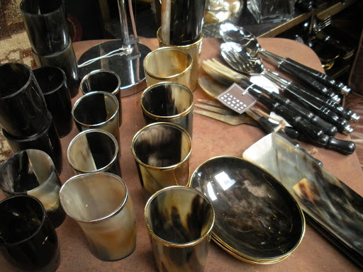 Cups and saucers made from horn are rimmed in gold and silver.
