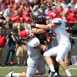 UM's Greg Hardy fights for extra yardage and gives South Dakota's Ryan Hillier (l) a little love tap in the process.  Washington - Grizzly Stadium, Montana Grizzlies vs. South Dakota Coyotes.  Missoula, MT, September 1st, 2012.
