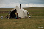 Children playing next to yurt