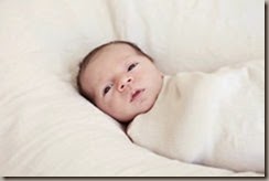 sweet-newborn-baby-swaddled-natural-blanket-eyes-open-30026265