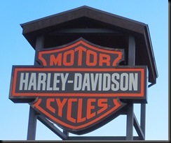 Mel's bike (helmet on ground beside it) at Pikes Peak Harley Davidson