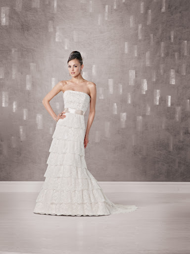 The silk ribbon on this layered lace Kathy Ireland gown adds a nice contrast. The silk ribbon on this layered lace Kathy Ireland gown adds a nice contrast.
