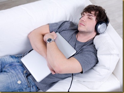 Sleeping man with headphone and laptop