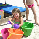 Putting sand in the bucket of water that Mommy just brought to me!
