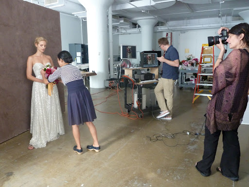 Here's a pulled-back shot, showing photographer Laurie Frankel framing up the shot, and Michael reviewing the photos as they come on to the screen.