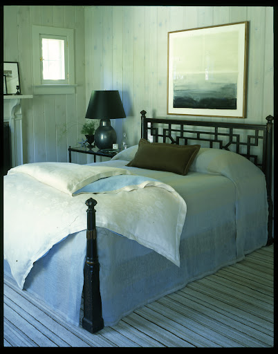 This geometric headboard is amazing and really stands out against the gray-washed walls.