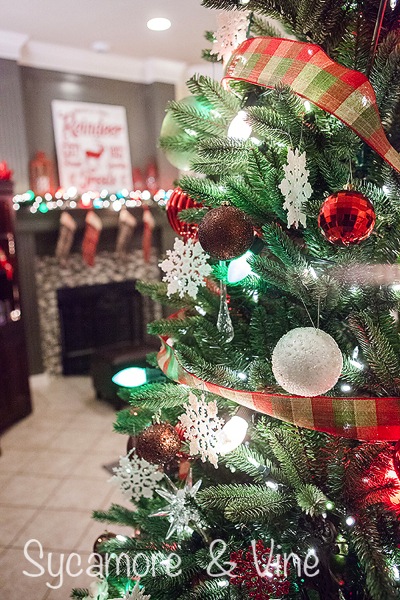 Use plaid ribbon on a plaid country Christmas inspired tree. A truly stunning Christmas Home Tour as part of the Christmas in the Country Blog Tour. This Plaid Inspired Country Christmas will knock your socks off. Features tours of the Living room, Dining Room and a Cocoa hot chocolate bar in the Breakfast room. There is so much inspiration for Christmas decorations in this one post. Be prepared to feel like you are cuddled up by the fire in a warm Northwoods comfy cottage! #country #Christmas #Plaid #Holiday decorating #Holiday ideas #Holidays #Christmas decor #Holiday decor Use plaid ribbon on a plaid country Christmas inspired tree. A truly stunning Christmas Home Tour as part of the Christmas in the Country Blog Tour. This Plaid Inspired Country Christmas will knock your socks off. Features tours of the Living room, Dining Room and a Cocoa hot chocolate bar in the Breakfast room. There is so much inspiration for Christmas decorations in this one post. Be prepared to feel like you are cuddled up by the fire in a warm Northwoods comfy cottage! #country #Christmas #Plaid #Holiday decorating #Holiday ideas #Holidays #Christmas decor #Holiday decor