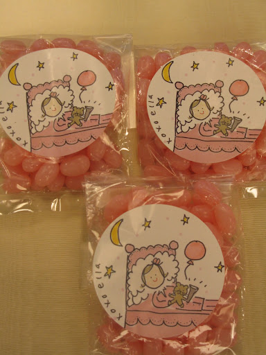 To decorate party favors, Darcy made custom stickers from drawings and pictures of Ella.