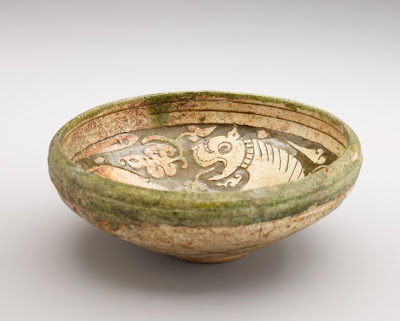 Bowl | Origin:  Iran | Period: 12th-13th century | Details:  Not Available | Type: Earthenware with decoration carved through a white slip and coloring under a transparent glaze | Size: H: 7.4  W: 19.6  cm | Museum Code: F1925.10 | Photograph and description taken from Freer and the Sackler (Smithsonian) Museums.