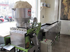 Masa loaded into the machine that will make tortillas