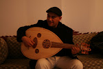 Riadh, Angela's oud/guitar instructor playing the oud in our living room in Nabeul.