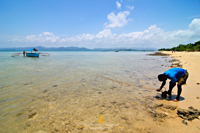 A Boatman Anchoring His Boat at Caramoan's Bagieng Island