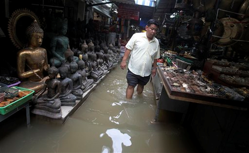 A Thai resident wades through a flooded area in Bangkok, Thailand, Monday, Oct. 3, 2011. Hundreds of people have died across Southeast Asia, China, Japan and South Asia in the last four months from prolonged monsoon flooding, typhoons and storms. Sakchai Lalit / AP Photo