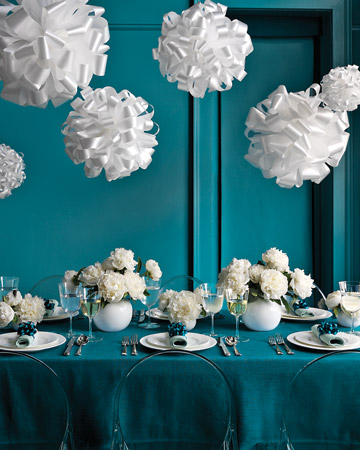 For a twist on the fancy chandelier, hang these fluffy pom-poms instead. (marthastewartweddings.com) For a twist on the fancy chandelier, hang these fluffy pom-poms instead. (marthastewartweddings.com)