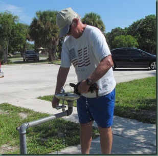 Al giving drink of water to gopher tortoise