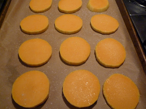 Slices of peeled butternut squash waiting for a drizzle of olive oil, and a sprinkling of salt, pepper, and sage.