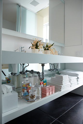In my main bathroom, mirror installed under the sink and below the shelf helps to brighten up the space and dark floor. In my main bathroom, mirror installed under the sink and below the shelf helps to brighten up the space and dark floor.